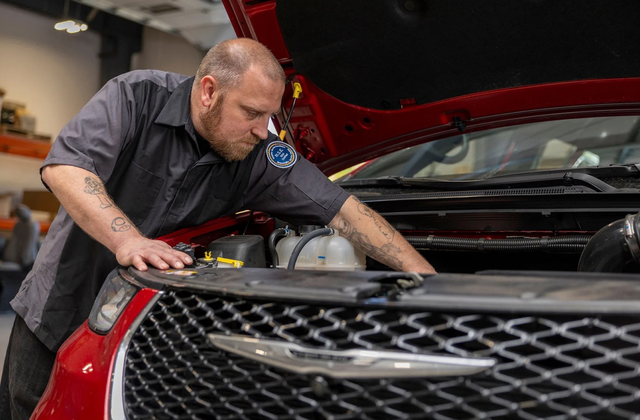 Certified Legacy Vans technician performing service work on a wheelchair-accessible vehicle