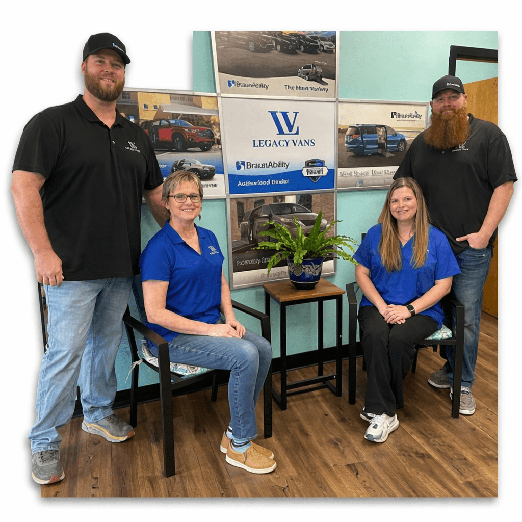 Legacy Vans team members standing and seated inside the showroom office